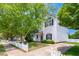 Charming two-story home with white siding, black shutters, and a well-manicured front yard and a white picket fence at 5016 Dawn Piper Dr, Raleigh, NC 27613