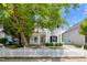 Charming two-story home with white siding, black shutters, and a well-manicured front yard and a white picket fence at 5016 Dawn Piper Dr, Raleigh, NC 27613