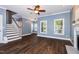 Comfortable living room with hardwood floors, a staircase leading up, and access to the fireplace at 5016 Dawn Piper Dr, Raleigh, NC 27613