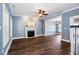 Inviting living room with hardwood floors, fireplace, and open access to dining area with modern chandelier at 5016 Dawn Piper Dr, Raleigh, NC 27613