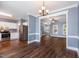 Open-concept living room with wood floors, crown molding, and an abundance of natural light at 5016 Dawn Piper Dr, Raleigh, NC 27613