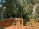 Inviting back deck adorned with hanging planters and view of the landscaped backyard at 511 Windstream Way, Cary, NC 27518