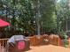 Wooden deck overlooking backyard with lush landscaping and grill at 511 Windstream Way, Cary, NC 27518