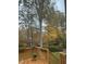 View of backyard and mature trees from the wooden deck at 511 Windstream Way, Cary, NC 27518