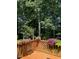 View of backyard and mature trees from the wooden deck with flower boxes at 511 Windstream Way, Cary, NC 27518
