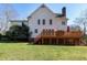 Two-story home with a spacious backyard and a large wooden deck with railings at 511 Windstream Way, Cary, NC 27518