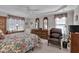 Comfortable bedroom featuring a ceiling fan, tray ceiling, and carpeted floors at 511 Windstream Way, Cary, NC 27518