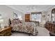 Comfortable bedroom featuring a ceiling fan, tray ceiling, and carpeted floors at 511 Windstream Way, Cary, NC 27518