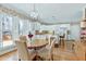 Bright dining area featuring a round table, stylish chandelier, and views of the backyard at 511 Windstream Way, Cary, NC 27518