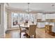 Inviting dining area with large windows, a round table, and floral wallpaper at 511 Windstream Way, Cary, NC 27518