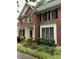 Charming brick home featuring an arched window, mature landscaping, and black shutters at 511 Windstream Way, Cary, NC 27518