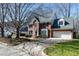 Traditional brick home boasting an attached two-car garage, beautiful lawn, and mature trees at 511 Windstream Way, Cary, NC 27518