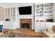 Close-up of a fireplace with white mantle, brick surround and flanking built-in cabinets at 511 Windstream Way, Cary, NC 27518