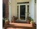Inviting entryway with brick steps and potted plants at front door with sidelight windows at 511 Windstream Way, Cary, NC 27518