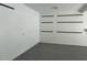 Clean garage interior with sealed floor and mounted storage supports at 511 Windstream Way, Cary, NC 27518