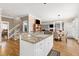 Open concept kitchen with granite counters, white cabinets, and seamless transition to living spaces at 511 Windstream Way, Cary, NC 27518
