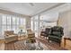 Inviting living room with large windows, plush seating, and decorative area rug at 511 Windstream Way, Cary, NC 27518