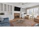 Cozy living room with a brick fireplace, built-in shelving, and classic furnishings at 511 Windstream Way, Cary, NC 27518