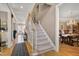 Elegant staircase connecting multiple levels, with hardwood floors and adjacent dining and living areas at 511 Windstream Way, Cary, NC 27518