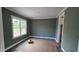 Bedroom with a window view, gray walls, white trim, and wood-look floors at 55 Livingston Ln, Spring Hope, NC 27882