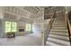 Spacious living room with staircase, fireplace, and natural light, showcasing modern design elements at 55 Livingston Ln, Spring Hope, NC 27882
