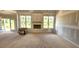 Bright living room featuring a fireplace with large windows providing scenic outdoor views at 55 Livingston Ln, Spring Hope, NC 27882
