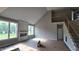 Living room featuring a fireplace, two windows, a metal staircase railing and high ceilings at 55 Livingston Ln, Spring Hope, NC 27882