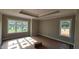 Spacious main bedroom featuring a tray ceiling and multiple windows offering ample natural light at 55 Livingston Ln, Spring Hope, NC 27882