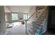 Living room staircase with metal railing and view of modern fireplace and windows at 55 Livingston Ln, Spring Hope, NC 27882