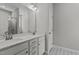Bright bathroom with double vanity, modern fixtures, and a tiled shower with glass door at 5601 Preston Pl, Raleigh, NC 27604