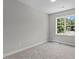 Comfortable bedroom with carpet and a window offering a view of the neighborhood at 5601 Preston Pl, Raleigh, NC 27604