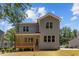 Two-story home features a wood porch and gray siding at 5601 Preston Pl, Raleigh, NC 27604