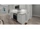 Eat-in kitchen featuring stainless appliances, white cabinets and stone countertops at 5601 Preston Pl, Raleigh, NC 27604