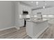 Modern kitchen features white cabinets, stainless steel appliances, granite counters and pendant lights over the island at 5601 Preston Pl, Raleigh, NC 27604