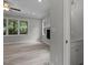 Open-concept floor plan showcasing a fireplace, large windows and a glimpse into the adjoining bathroom at 5601 Preston Pl, Raleigh, NC 27604