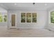 Light and bright living area with multiple windows and glass paneled door leading to porch at 5601 Preston Pl, Raleigh, NC 27604
