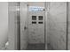 Modern shower with sleek marble-style tiling, built-in niche, and a rainfall shower head at 5601 Preston Pl, Raleigh, NC 27604