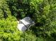 Aerial view of a home showcasing the roof and lush, green surroundings at 574 Chatham Dr, Chapel Hill, NC 27516