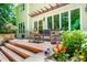 Spacious back deck with seating, a dining area, and beautiful landscaping offers an ideal outdoor living space at 574 Chatham Dr, Chapel Hill, NC 27516