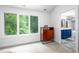 Comfortable bedroom with large windows and an adjoining bathroom with double sink vanity at 574 Chatham Dr, Chapel Hill, NC 27516