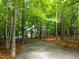 Long driveway leading to a home surrounded by mature trees offers seclusion at 574 Chatham Dr, Chapel Hill, NC 27516