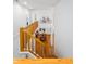 Open foyer with wood floors, second story balcony with wood railing and decorative bicycle on the wall at 574 Chatham Dr, Chapel Hill, NC 27516