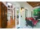 Cozy front porch features comfortable seating, brick flooring, and a glimpse into the home's spacious, well-lit interior at 574 Chatham Dr, Chapel Hill, NC 27516