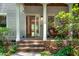 Inviting front porch with a cozy seating area, a wood ceiling, and a glimpse of the interior through the open door at 574 Chatham Dr, Chapel Hill, NC 27516