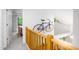 Hallway featuring wood railings, bicycle art, and views into the bedrooms and living spaces at 574 Chatham Dr, Chapel Hill, NC 27516
