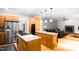 Open kitchen features a gas range, stainless steel refrigerator, island, and hardwood floors at 574 Chatham Dr, Chapel Hill, NC 27516