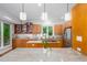Spacious well lit kitchen with custom wood cabinets, granite countertops, and stainless steel appliances at 574 Chatham Dr, Chapel Hill, NC 27516