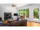 Bright living room featuring a fireplace, hardwood floors, and large windows with natural light at 574 Chatham Dr, Chapel Hill, NC 27516