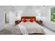 Light main bedroom with large windows, a comfortable bed, and ample natural light at 574 Chatham Dr, Chapel Hill, NC 27516