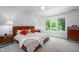 Cozy main bedroom with large windows, a comfortable bed, and ample natural light at 574 Chatham Dr, Chapel Hill, NC 27516